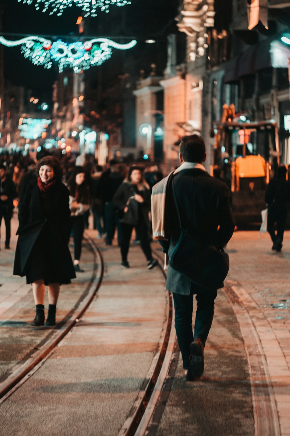 people walking at the streets of the city during night