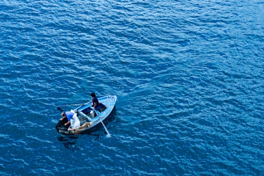 three person riding boat in Sorrento Italy