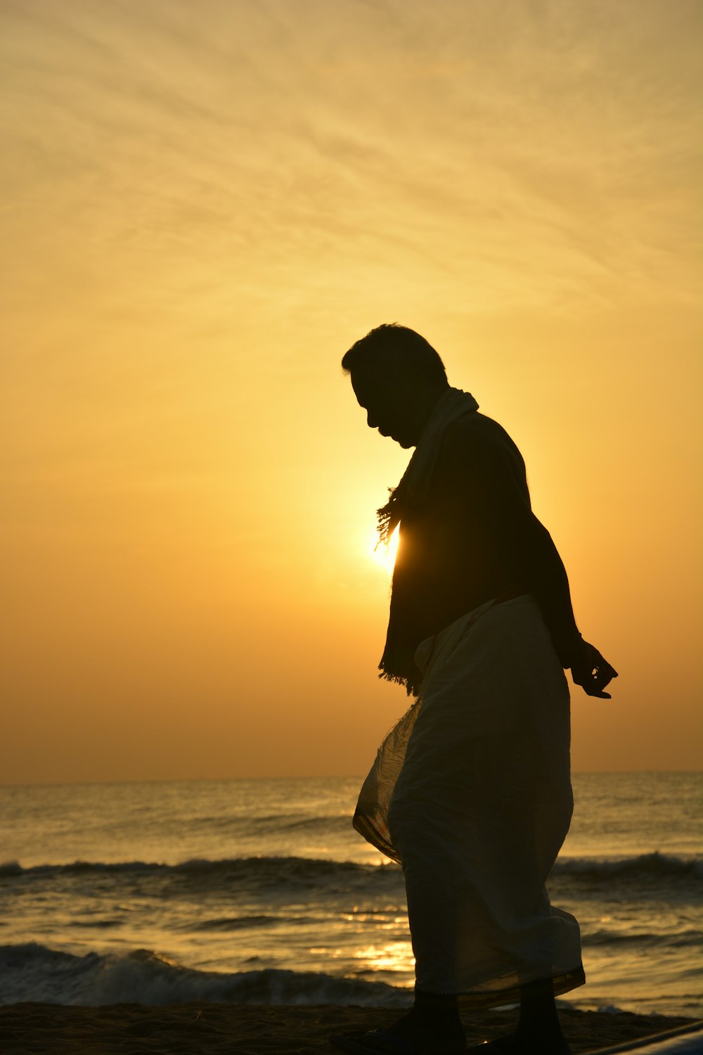 silhouette of person near ocean