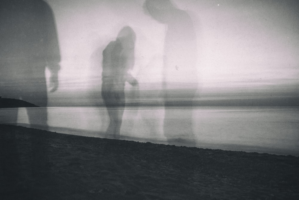 a group of people standing next to a body of water