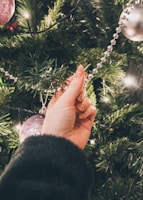 Family gathered around the tree, placing garlands and sharing laughter.