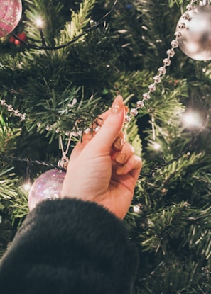 Family gathered around the tree, placing garlands and sharing laughter.