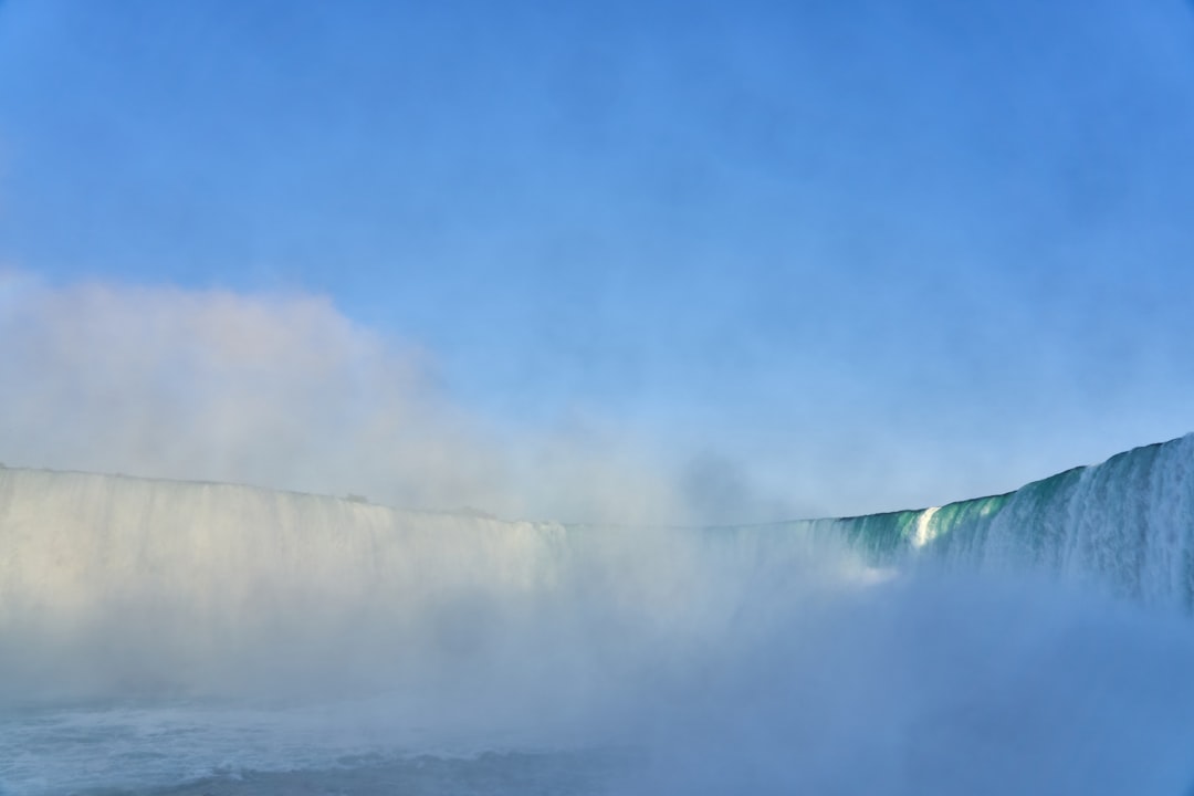 waterfalls under blue and white sky