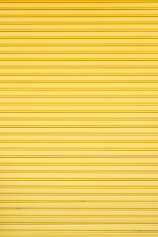 a yellow garage door that is closed