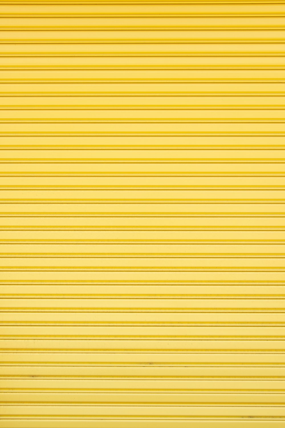 a yellow garage door that is closed