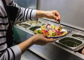 person filling her plate