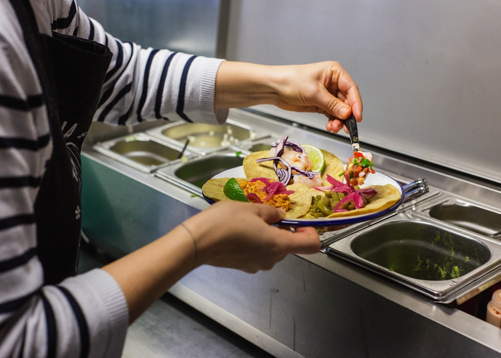 person filling her plate