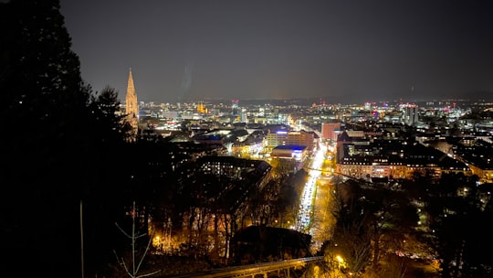 lighted city buildings and streets during night time in Schlossbergrestaurant Dattler Germany