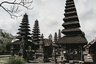 a group of stone structures with trees in the background