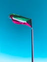 a flag flying in the wind on a beach