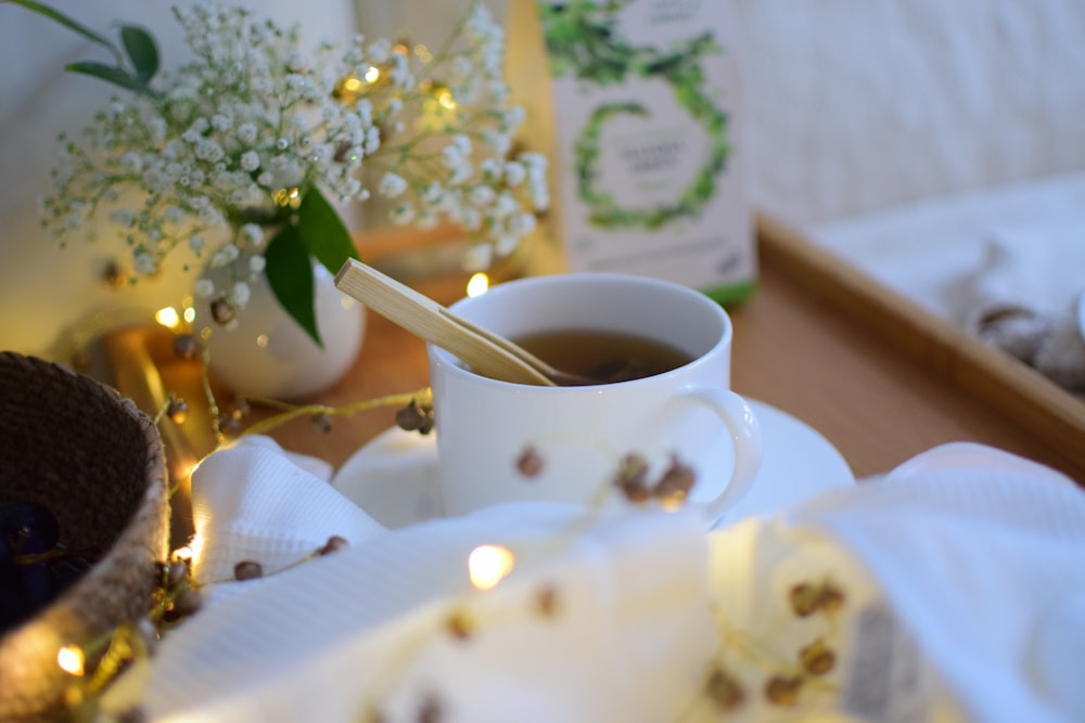 white teacup with saucer