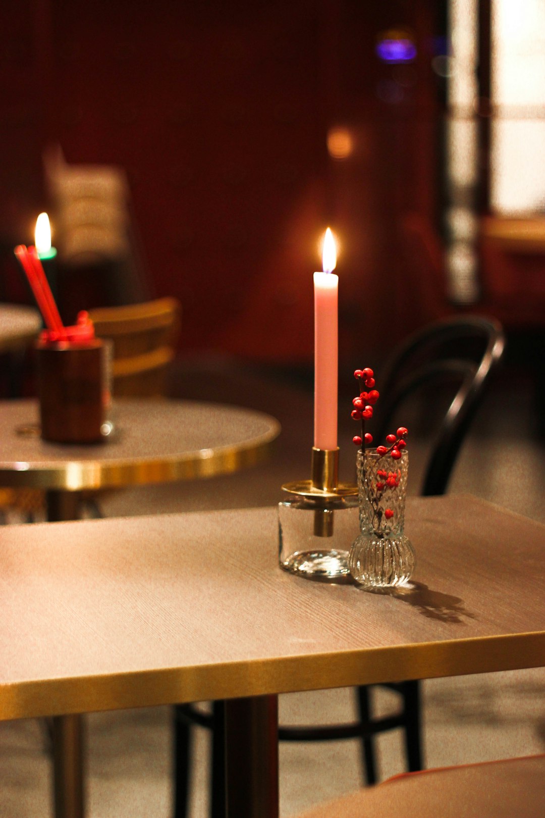 lit candle stick on holder on table