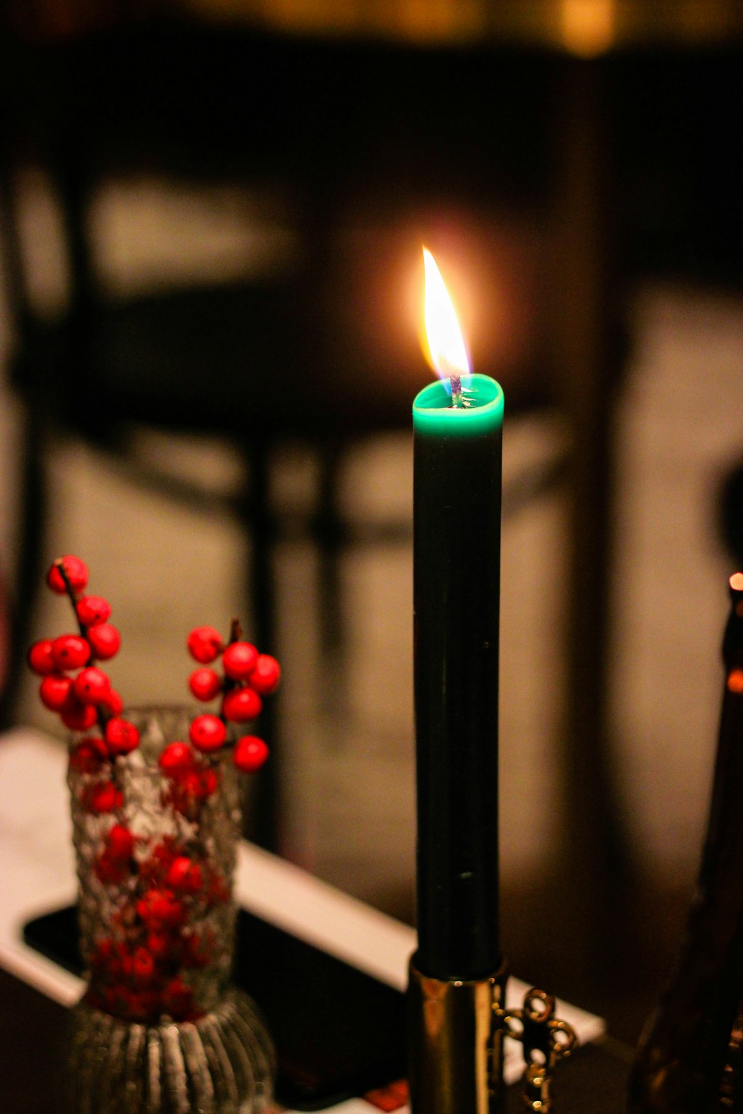lighted green candle stick with holder