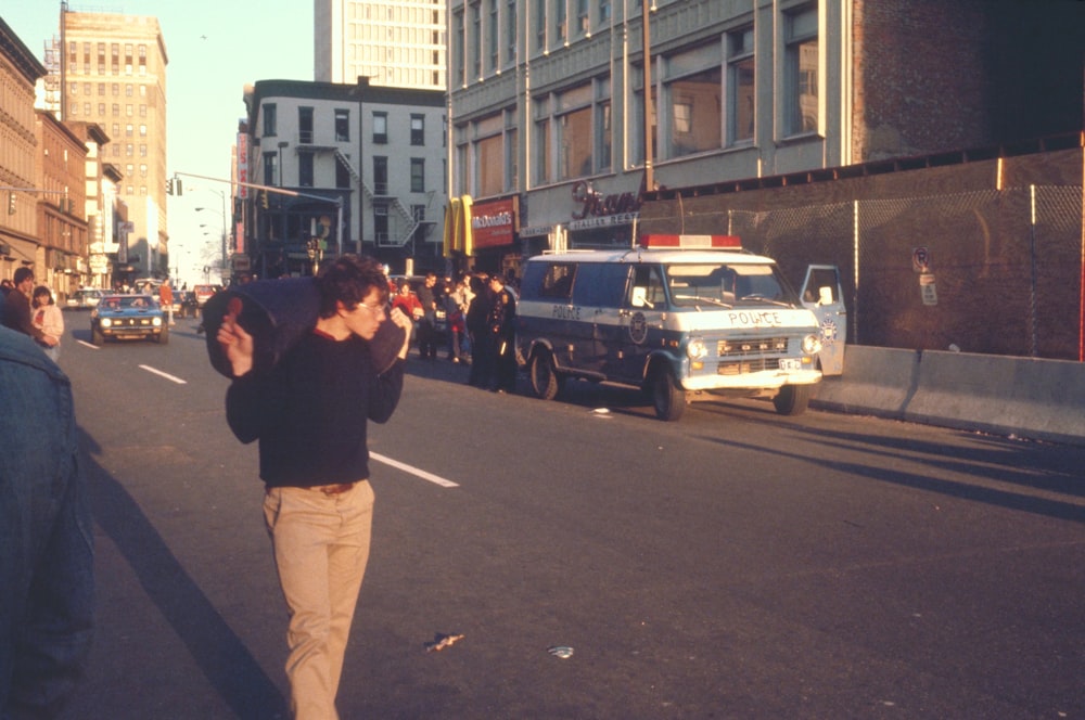 people near gray car during daytime