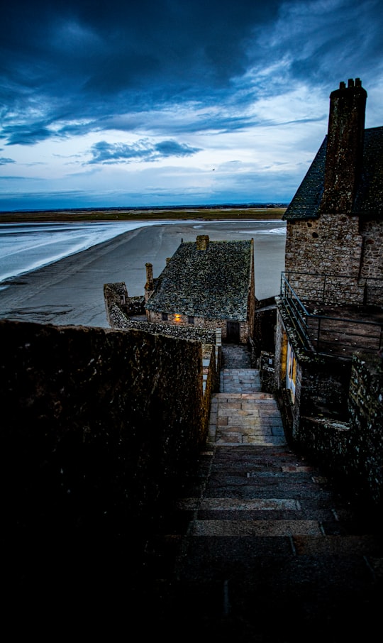 aerial photography of houses near body of water under blue sky in Mont Saint-Michel France