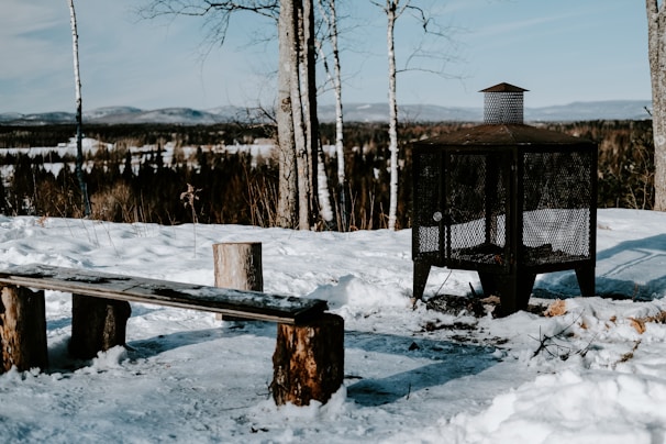 Outdoor fire pit area with comfortable seating overlooking a winter landscape.