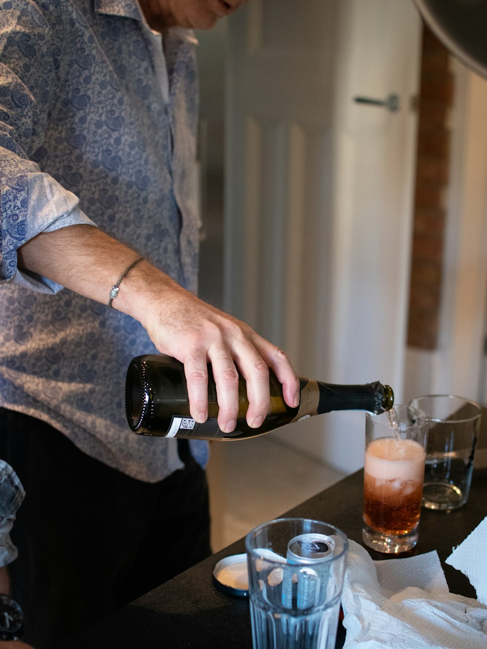 person pouring dink in cup