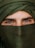 a close up of a person wearing a green head scarf