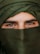a close up of a person wearing a green head scarf