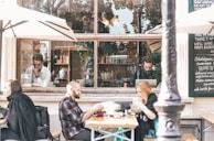 A cozy café terrace with people enjoying their drinks.