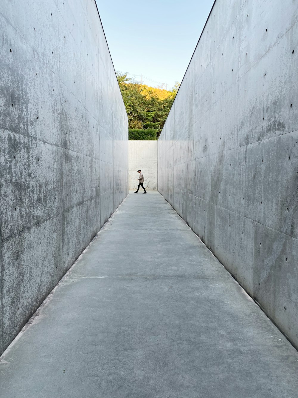 man walking along a narrow pathway