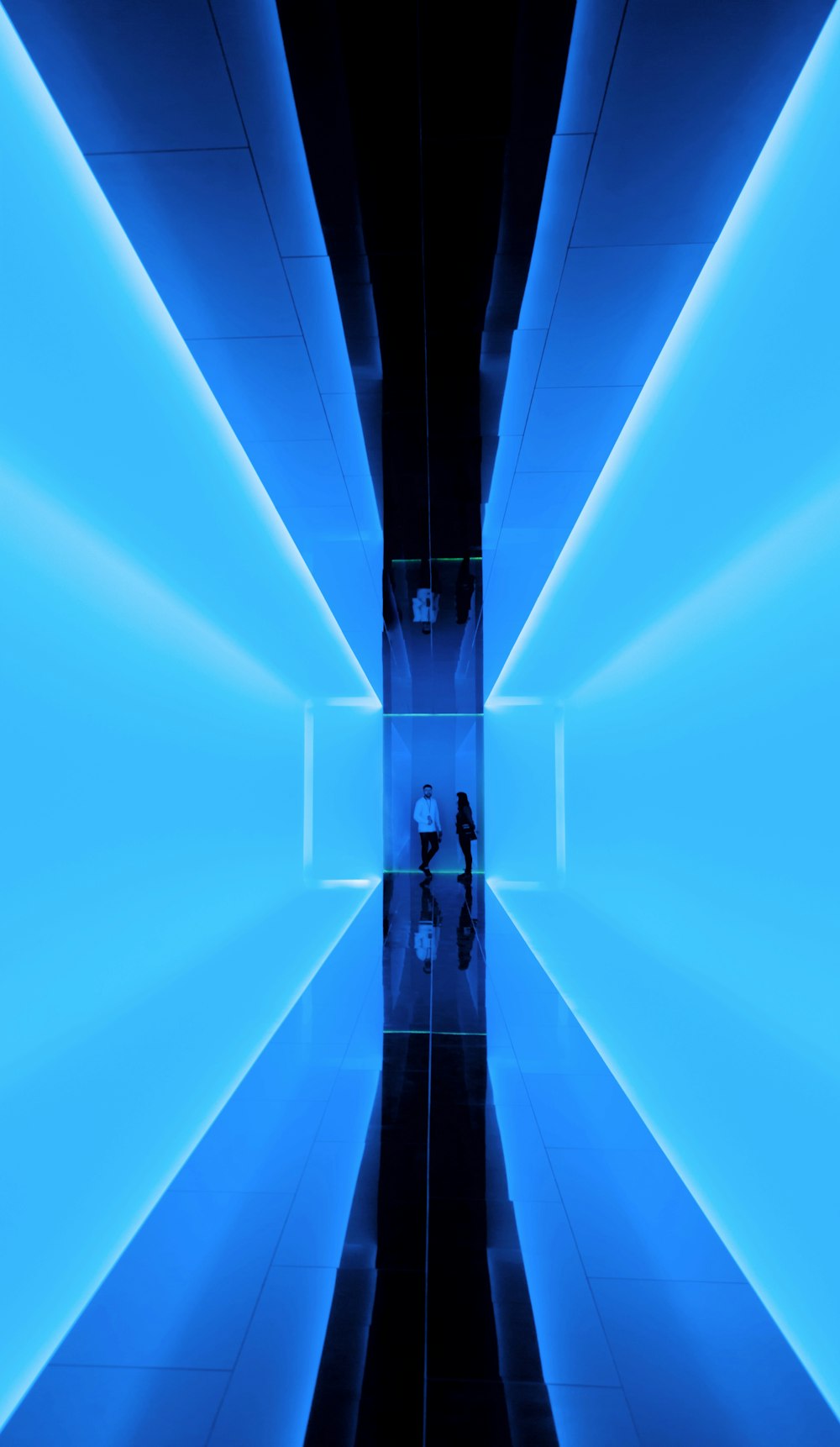 a person standing in a room with blue lights
