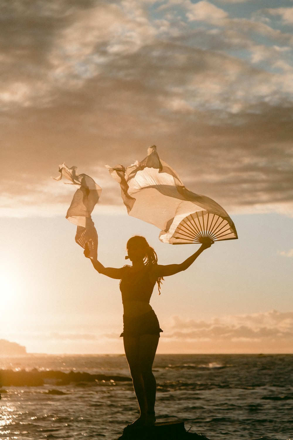 woman waving hand fans