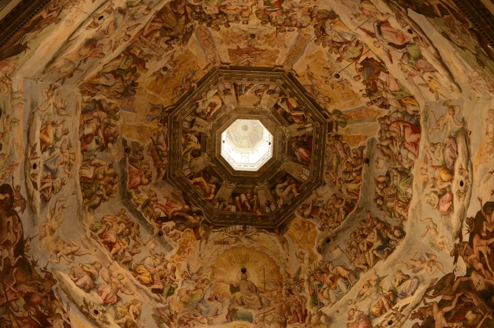 the ceiling of a church with paintings on it