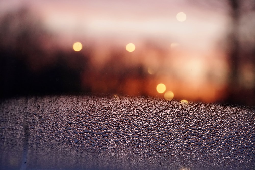 a blurry photo of a window with rain drops