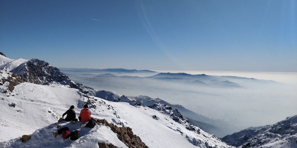 two person on hill mountain covered with snow