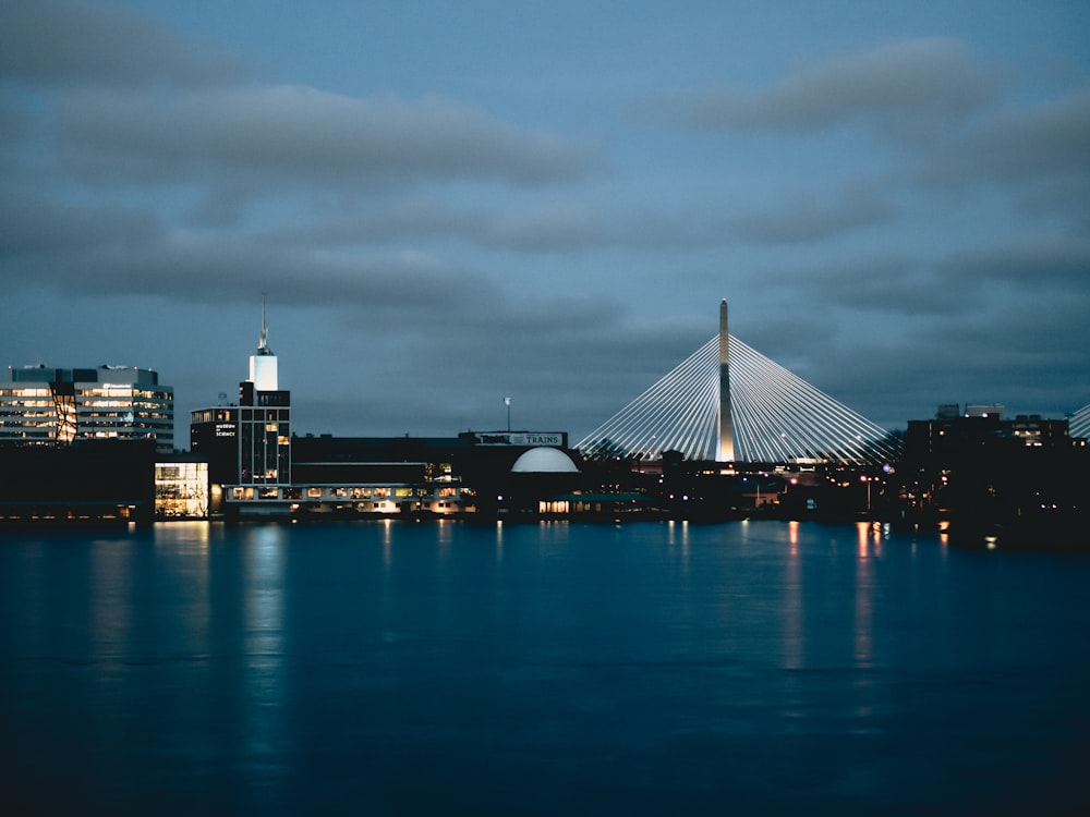 lighted buildings near body of water