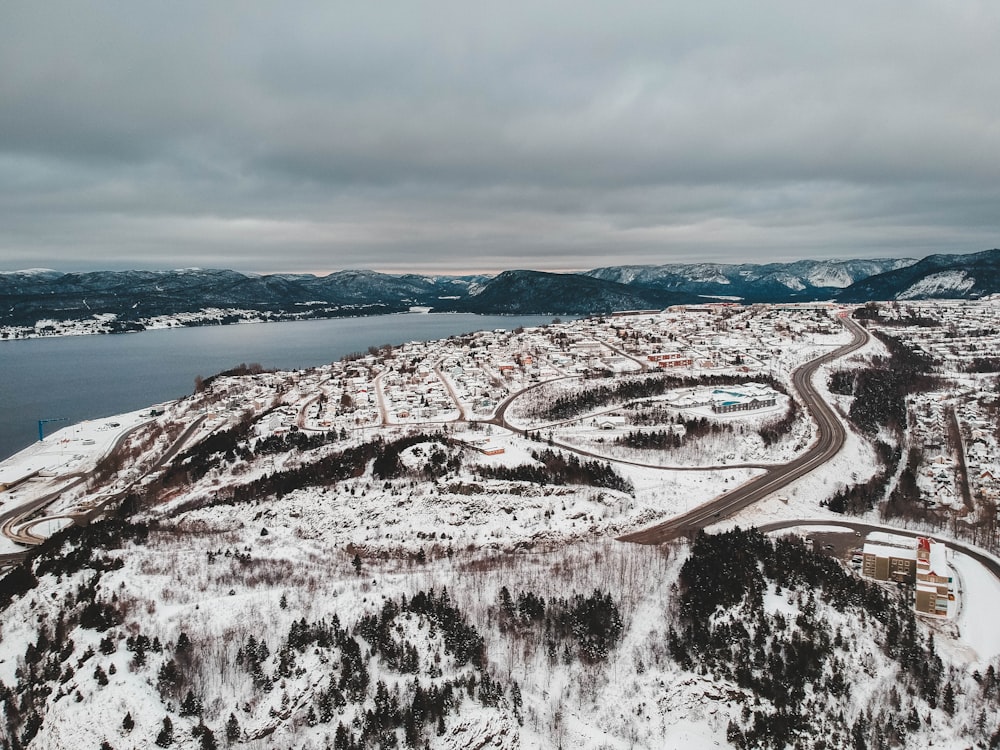 road near body of water covered with snow