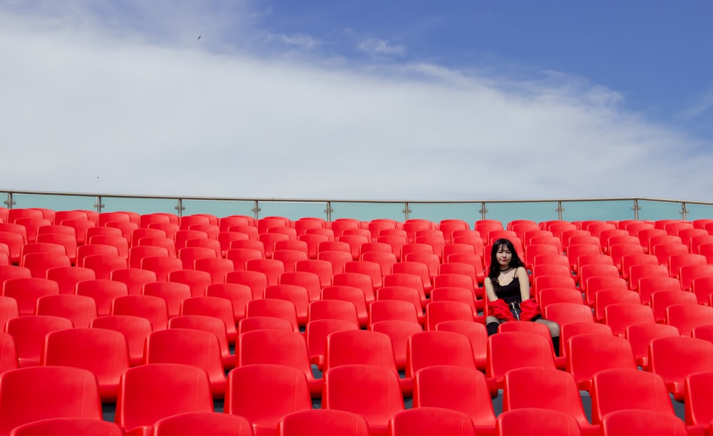 woman sitting on red chair\