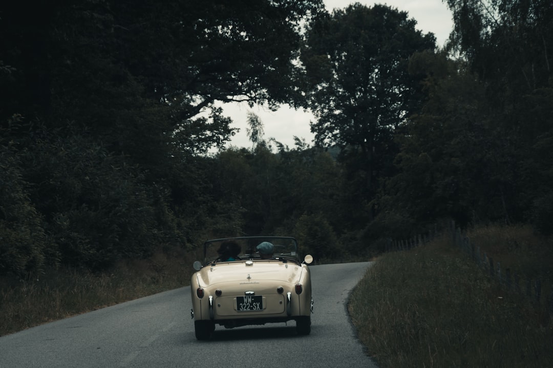 person riding gray convertible coupe