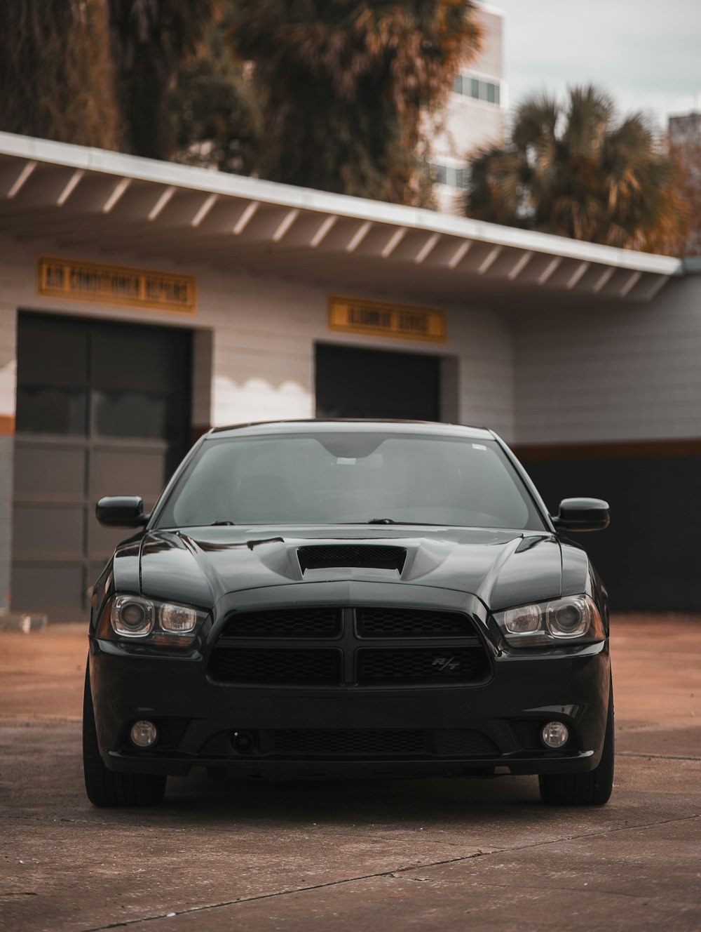 a black car parked in front of a building