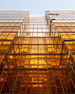 Cinematic shot of sleek glass buildings in Brussels' European quarter reflecting the morning light.