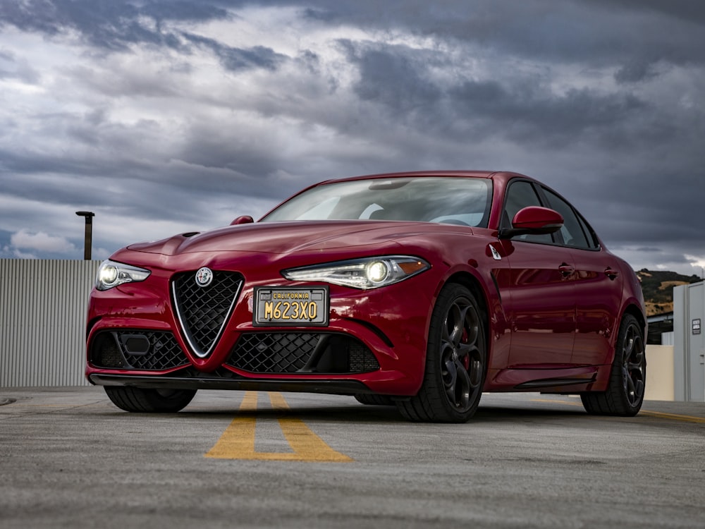 selective focus photography of parked red sedan