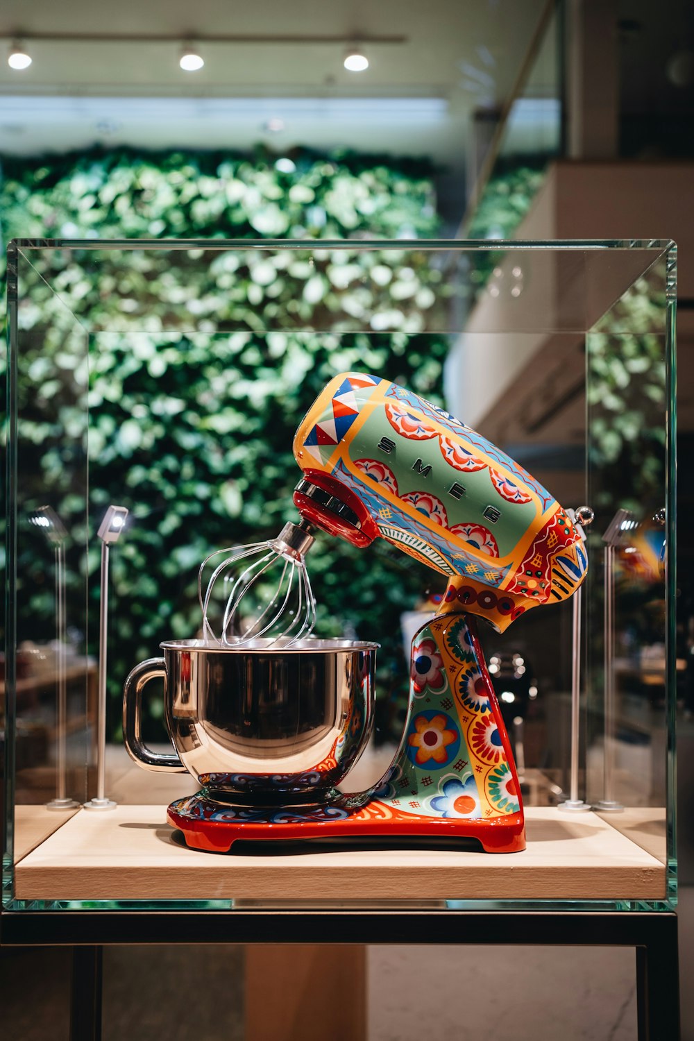 multicolored stand mixer with glass case