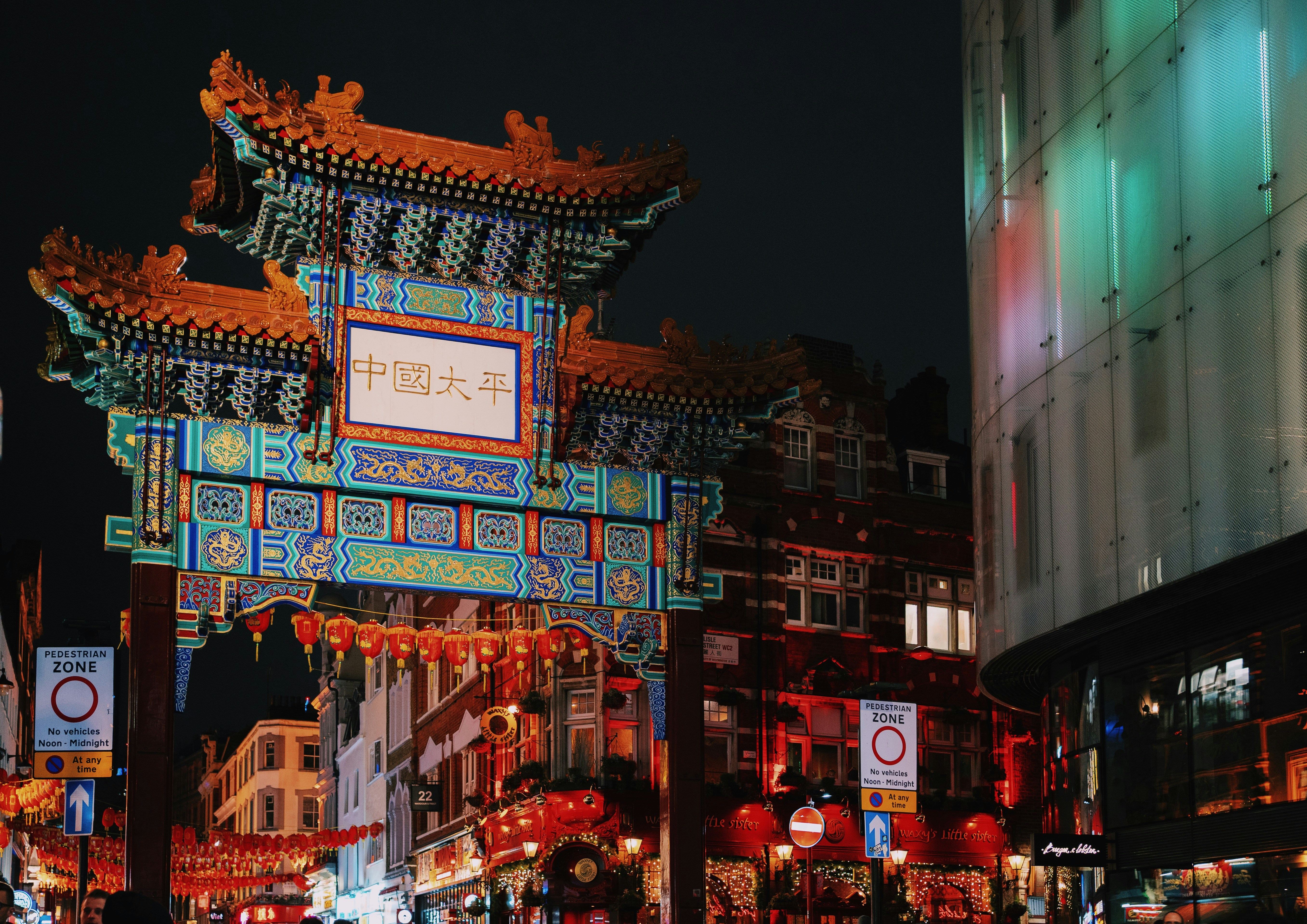 blue and red pagoda gateway during nighttime