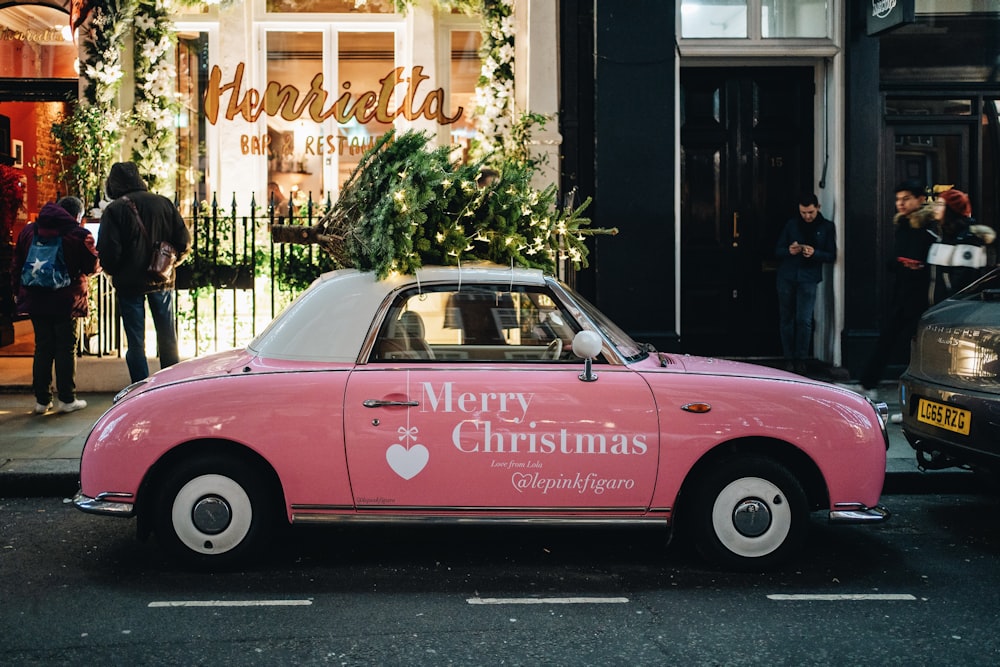 a pink car parked in front of a store