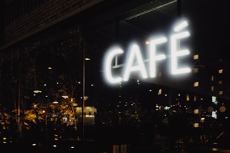 white cafe neon light signage during nighttime