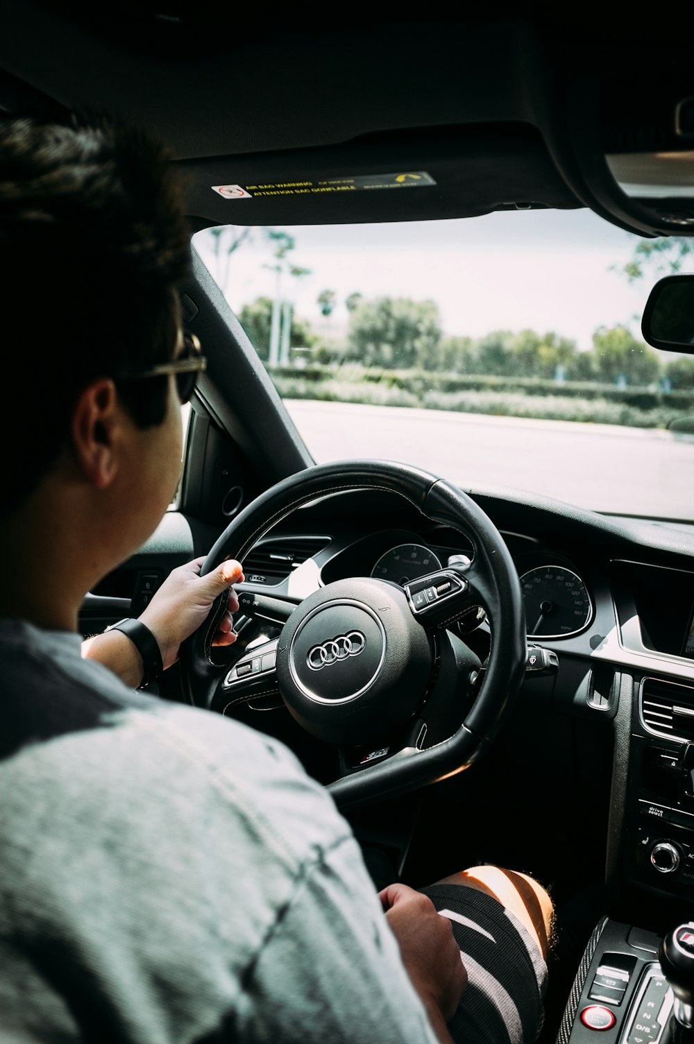 man driving an Audi car