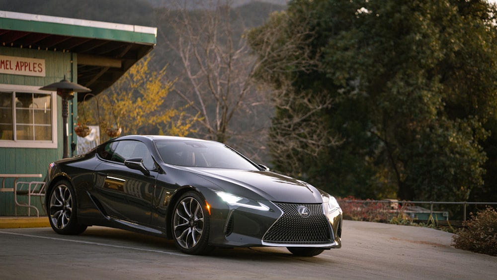 gray Lexus coupe parked in front of building