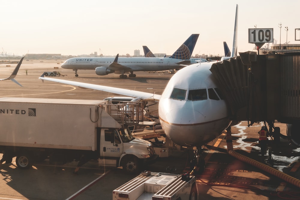 white airplanes at airport during daytime