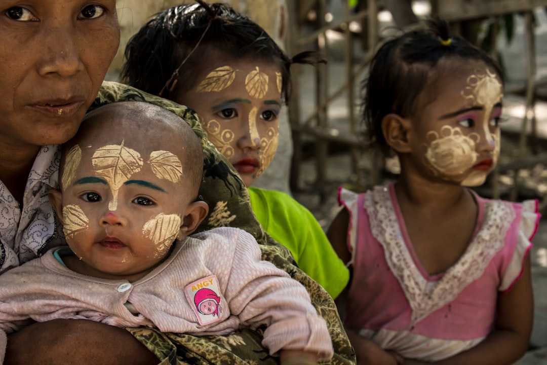 children with leaves painted on their faces
