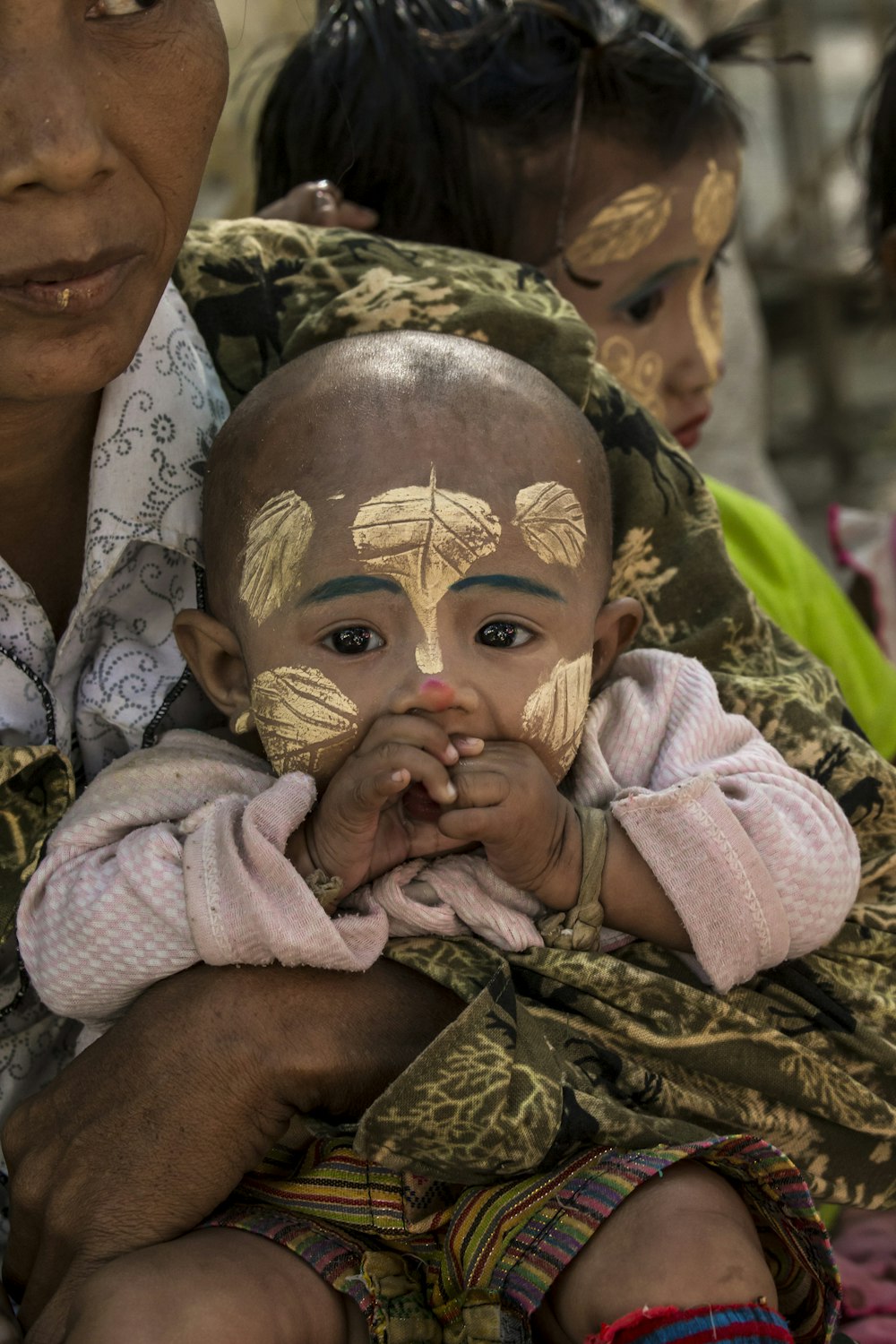 baby with gold floral face paint