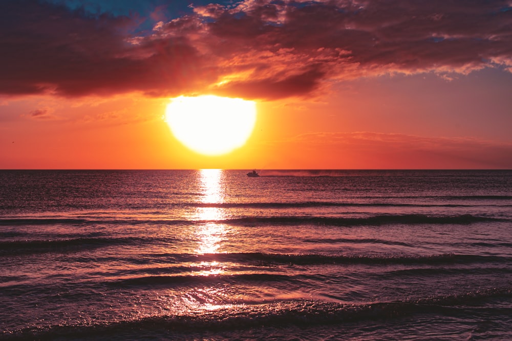 sea under cloudy sky during golden hour