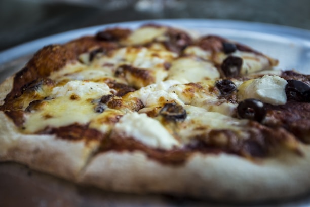 Close-up of a delicious homemade pizza fresh out of the oven at Drako Pizza.