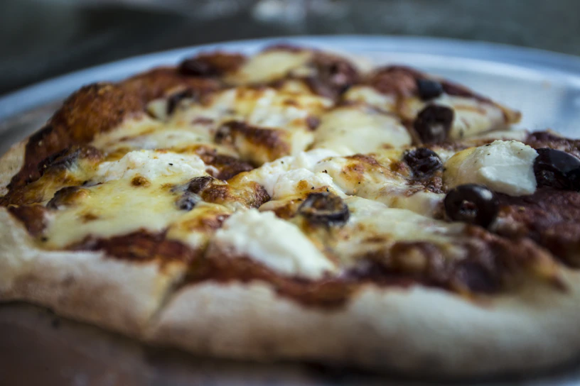 Close-up of a sizzling Boss Special pizza fresh out of the oven with melted cheese and vibrant toppings.