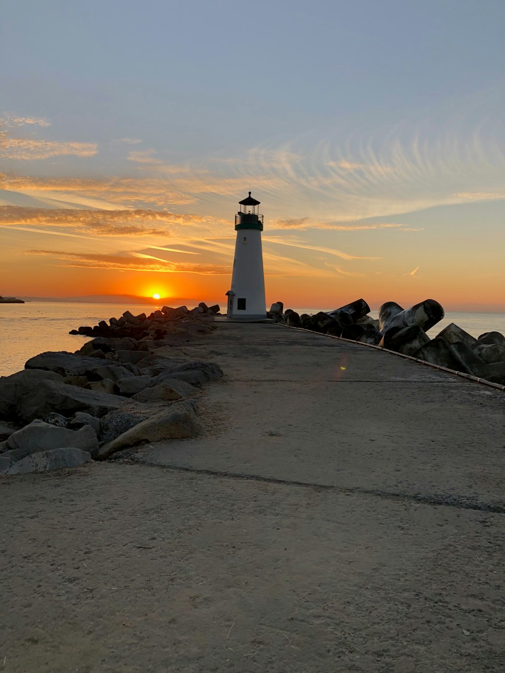 lighthouse by the seashore during golden hour